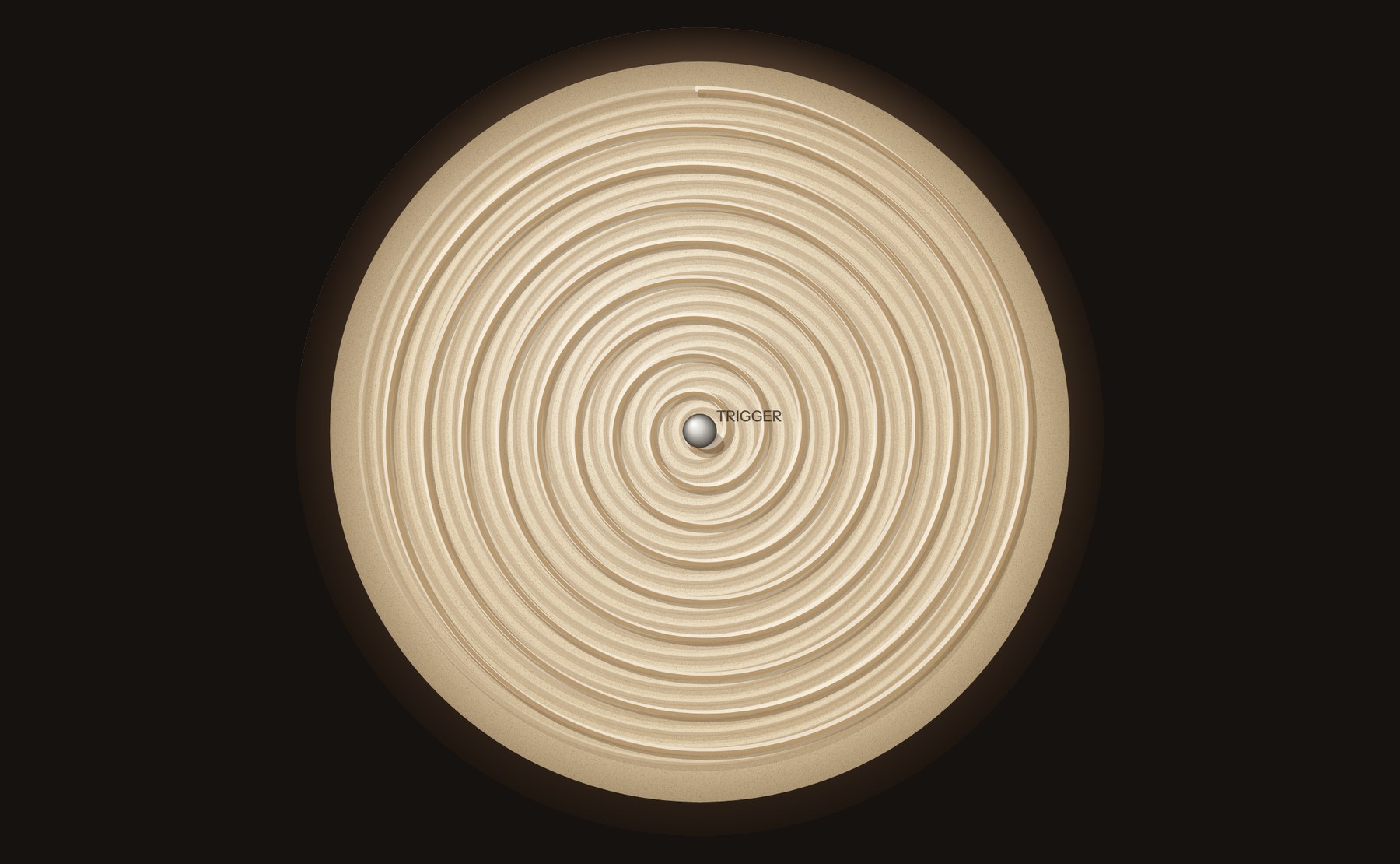 A sand table: a spiral drawn inward to a single point, a steel ball at its centre